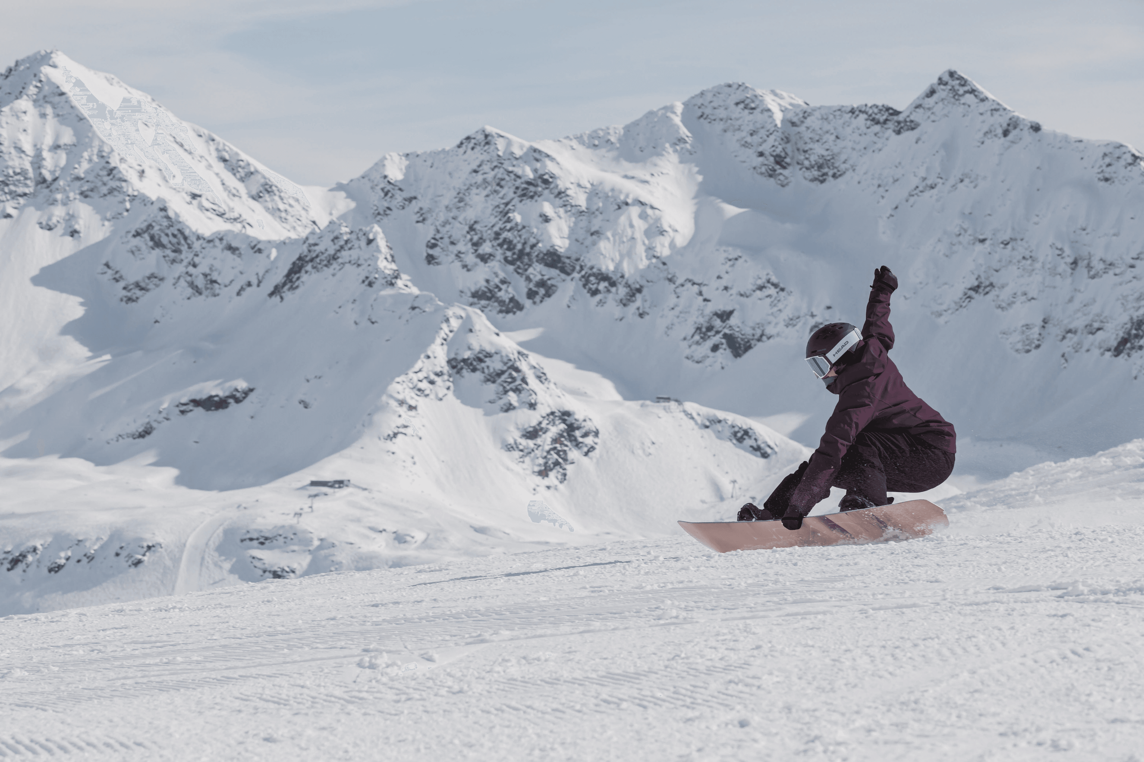 Snowboarder carving down a mountain slope